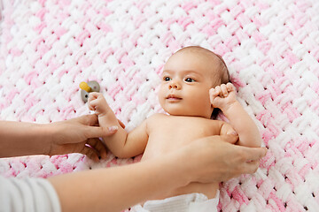 Image showing sweet baby girl lying on knitted plush blanket