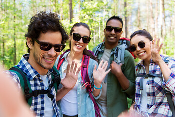 Image showing friends with backpacks hiking and taking selfie