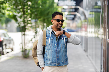 Image showing indian man recording voice message by smart watch