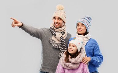 Image showing happy family in winter clothes on grey background