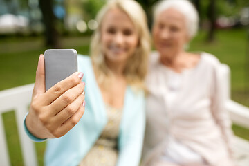 Image showing daughter and senior mother taking selfie at park