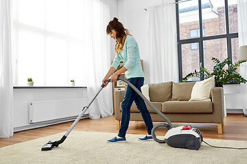 Image showing asian woman with vacuum cleaner at home