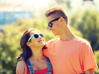 Image showing happy teenage couple looking at each other in park