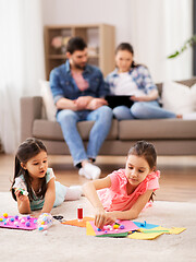 Image showing happy sisters doing arts and crafts at home