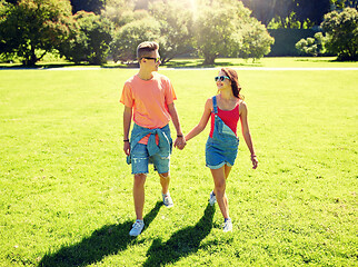 Image showing happy teenage couple walking at summer park