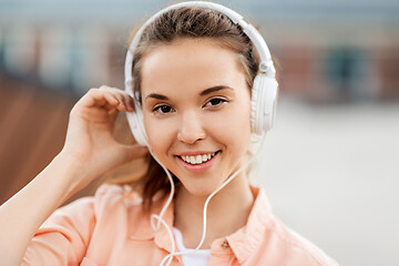 Image showing portrait of teenage girl in headphones in city