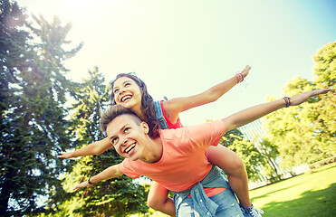 Image showing happy teenage couple having fun at summer park