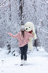 Image showing Woman standing in the snow covered pine forest in winter