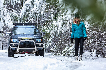 Image showing Out in snow covered forest with 4wd ute