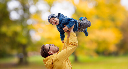 Image showing father with son playing and having fun in autumn