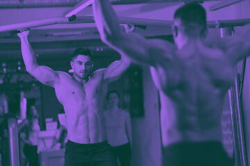 Image showing handsome man exercising at the gym