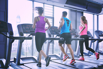 Image showing Group of people running on treadmills