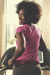 Image showing afro american woman running on a treadmill