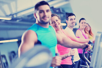 Image showing Group of people running on treadmills