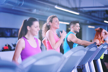 Image showing Group of people running on treadmills