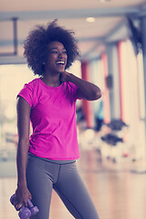 Image showing woman working out in a crossfit gym with dumbbells