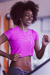 Image showing afro american woman running on a treadmill