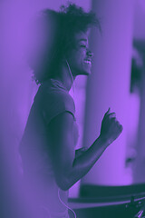 Image showing afro american woman running on a treadmill