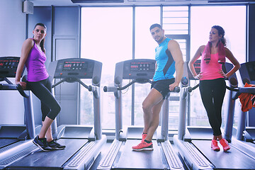 Image showing Group of people running on treadmills