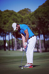 Image showing golf player hitting shot at sunny day