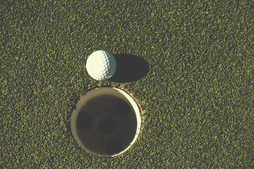 Image showing top view of golf ball in the hole