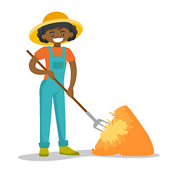 Image showing A black happy woman with a pitchfork and a haystack.