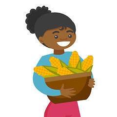 Image showing A black happy woman with a basket of corncobs.