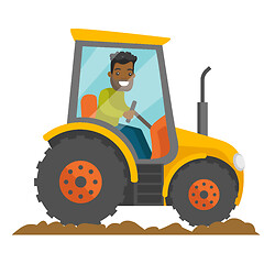 Image showing A black happy farmer in tractor on a rural farm field.