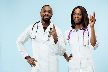 Image showing The female and male happy afro american doctors on blue background