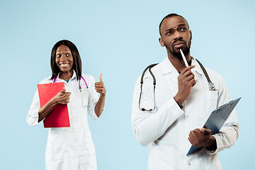 Image showing The female and male happy afro american doctors on blue background