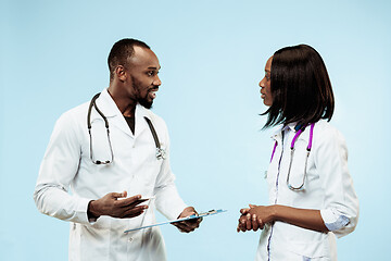 Image showing The female and male happy afro american doctors on blue background