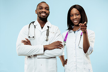 Image showing The female and male happy afro american doctors on blue background