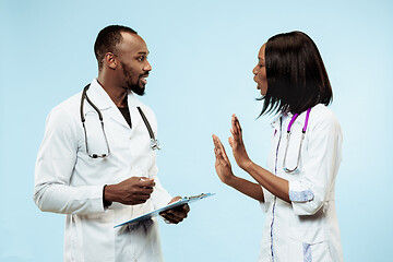 Image showing The female and male happy afro american doctors on blue background