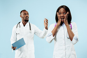 Image showing The female and male happy afro american doctors on blue background