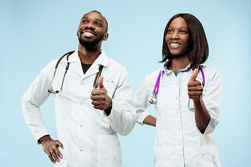 Image showing The female and male happy afro american doctors on blue background