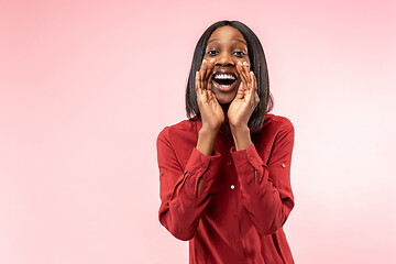 Image showing Isolated on pink young casual afro woman shouting at studio