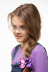 Image showing Portrait of a girl in round glasses with an interesting and distracted look