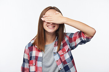 Image showing Emotional joyful teen girl covering her eyes with palm