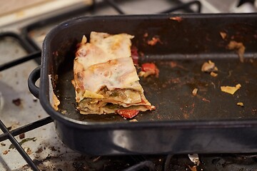 Image showing Lasagna leftover in a dirty kitchen