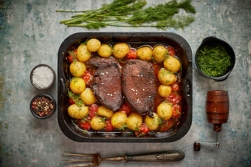 Image showing Delicious roasted goose breast served with vegetables, potatoes.