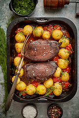 Image showing Delicious roasted goose breast served with vegetables, potatoes.