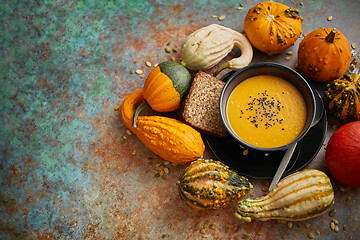 Image showing Compositon with autumn classic food. Tasty homemade pumpkin soup