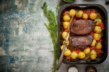 Image showing Roasted duck breast with golden crispy skin served with baked po