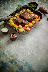 Image showing Roasted duck breast with golden crispy skin served with baked potatoes, sprinkled with dill