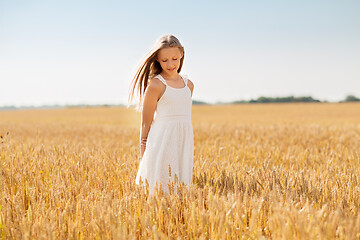 Image showing smiling young girl on cereal field in summer