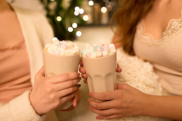 Image showing two women drinking hot chocolate with marshmallow