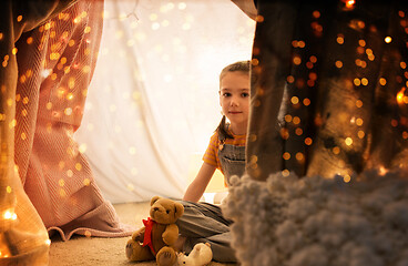 Image showing little girl with toys in kids tent at home