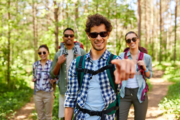 Image showing friends with backpacks on hike in forest