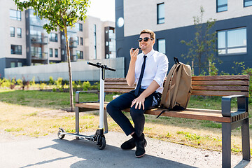 Image showing businessman recording voice message by smartphone