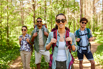 Image showing friends with backpacks on hike in forest